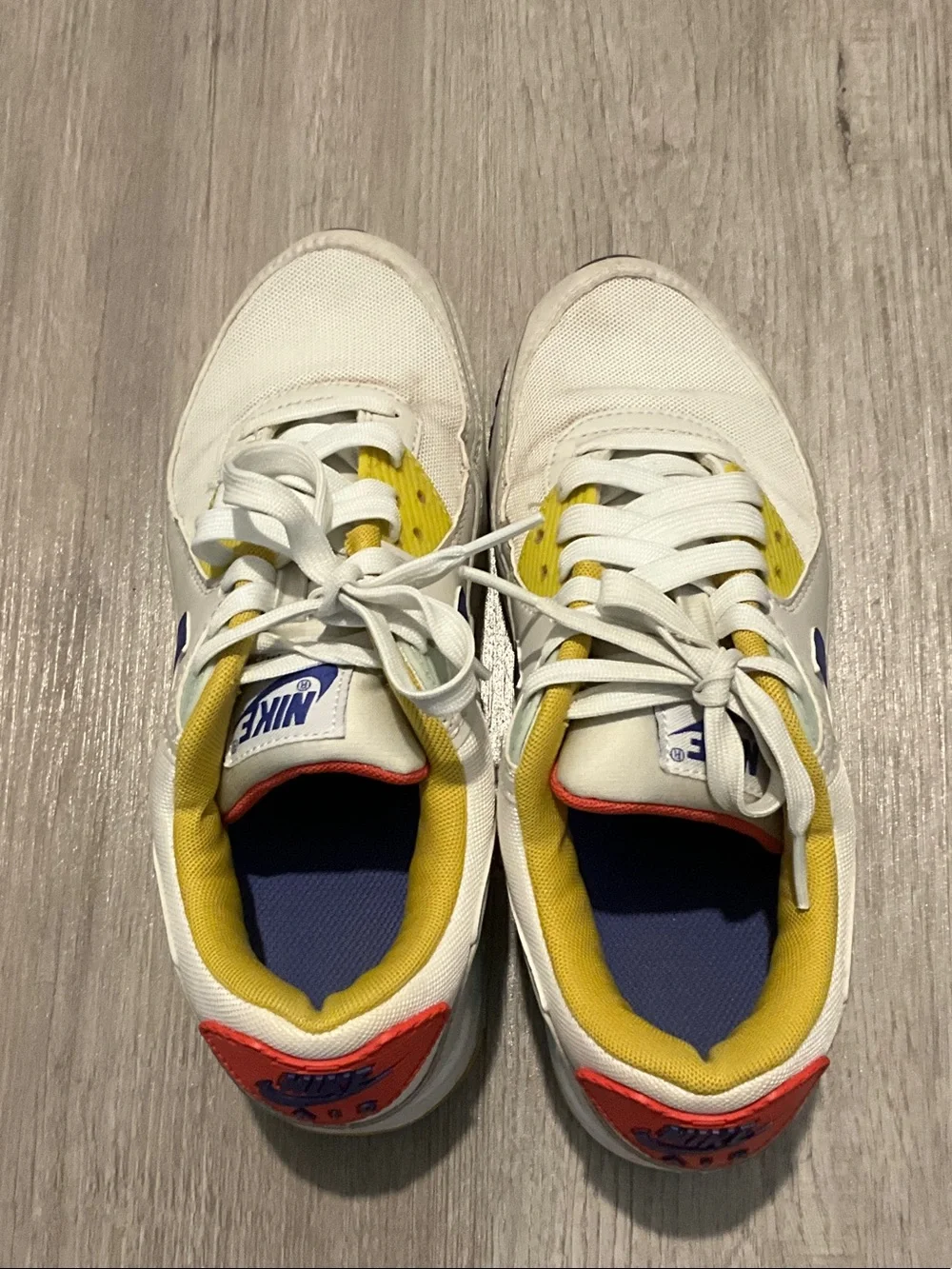 Nike White Sneakers with Blue, Yellow and Red Accents